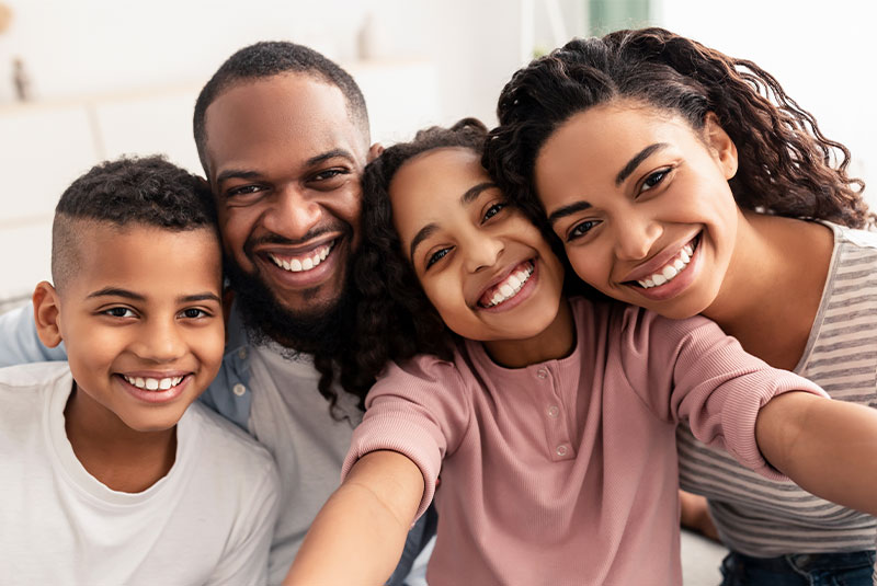 group image of family smiling after dental procedure